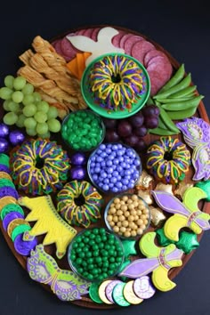 a platter filled with lots of different types of food on top of a table