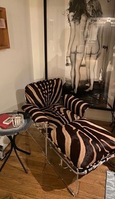 a zebra print chair sitting next to a glass table