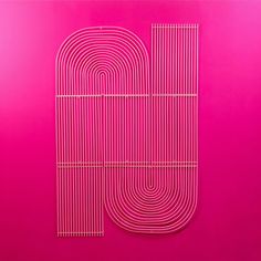 a pink poster with the letter u in it's center and lines on top