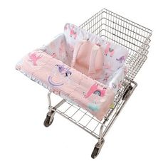 a baby's shopping cart with a pink blanket on top and unicorns all over it