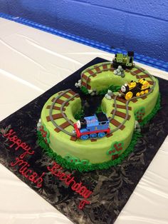 a birthday cake that is shaped like a train