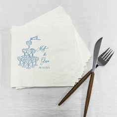 napkins with blue ink on them sitting next to utensils