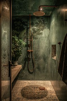 a bathroom with green walls and tiled flooring, shower head is on the wall