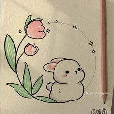 a drawing of a little bunny with flowers on it's side and a pencil in the foreground