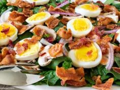 a salad with hard boiled eggs and bacon