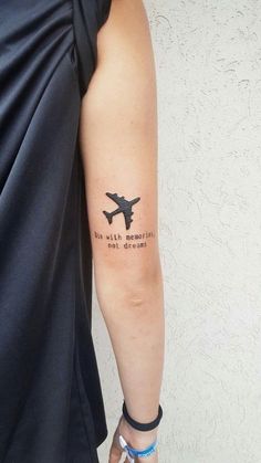 a person with a tattoo on their arm that says, we wish to fly somewhere