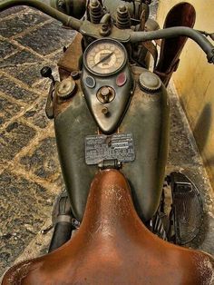 an old motorcycle is parked on the street