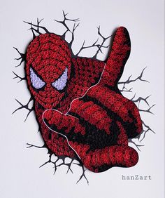 a crocheted spider man laying on its side