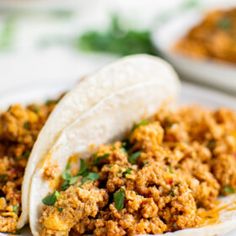 two tacos filled with meat and vegetables on a plate