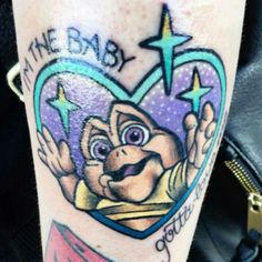 a tattoo with an image of a cartoon character on it's leg and the words, i am the baby