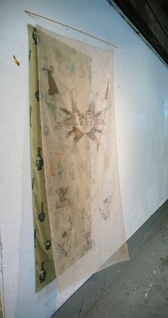 two pieces of cloth hanging on the wall