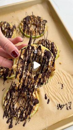 someone is sprinkling chocolate on an apple with caramel and nutcrackers