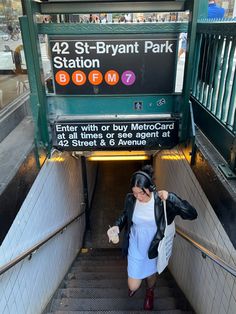 a woman is walking up the stairs at station 54