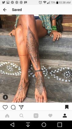 a woman's legs with tattoos on them sitting on the steps next to stairs