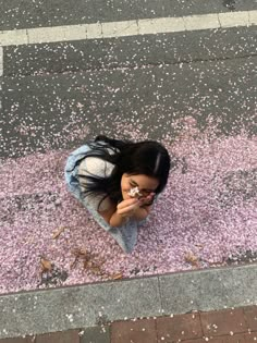 a woman sitting on the ground eating food