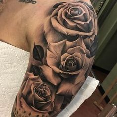 black and grey roses tattoo on the arm