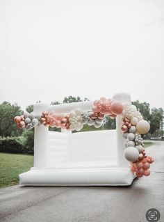 an arch decorated with balloons and flowers