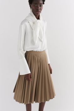 Our Khaki contrast pleated skirt is made of 100% wool, woven in Yorkshire at the mill Alfred Brown. The skirt is hand pleated in London. The skirt features two contrast pleats and a side entry invisible zip. Plated Skirt, Pleats Skirt, Knife Pleat, Tailored Coat, Ivory Silk, The Mill, Khaki Dress, Invisible Zip, Navy Women