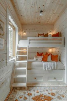 a bunk bed in a room with white walls and wood flooring on the ceiling