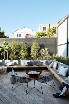 an outdoor living area with couches and tables