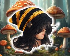 a crocheted hat with yellow and black stripes on it, surrounded by mushrooms