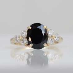 a black and white diamond ring sitting on top of a table