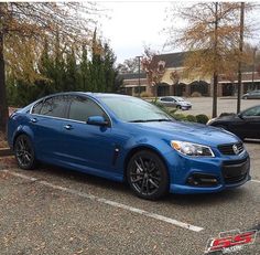 a blue car parked in a parking lot