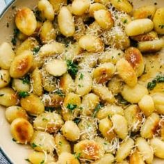 pasta with parmesan cheese and herbs in a bowl