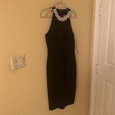 Beautiful Black Dress. Midi Length And Size 6. In Pristine Condition. Features High Neck And Pearl And Crystal Neckline. Wonderful For The Holidays Or Any Occasion! Elegant Embellished Midi Dress For Dinner, Black Embellished Midi Dress For Date Night, Elegant Embellished Midi Dress For Date Night, Elegant Silver Dress For Date Night, Elegant Fitted Silver Midi Dress, Elegant Sleeveless Silver Midi Dress, Elegant Silver Midi Dress For Formal Occasions, Elegant Silver Midi Dress For Cocktail, Silver Elegant Cocktail Midi Dress