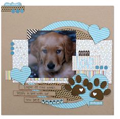 a scrapbook page with a dog's paw and heart shaped tags on it