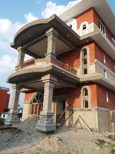 a large red brick building with many windows and balconies on the second floor