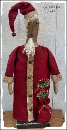 an old fashioned santa clause doll is on display