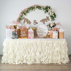 a table topped with bags and gifts under a mr and mrs sign on the wall