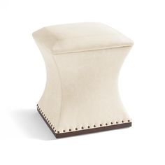 a white stool with studded legs on an isolated surface, viewed from the side