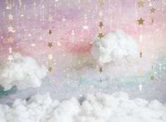 there are stars and clouds in the sky above the clouds, as if they were falling down