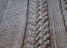 there is a knitted blanket that looks like an intricate design on the side of it