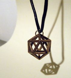 This is a simple wire-frame version of an icosahedron, 20 sided platonic solid. This 3D printed necklace is perfect and elegant. It ships on a black cord necklace. 3d Print Necklace, 3d Printed Charms, 3d Printed Necklace, Charm Ideas, Platonic Solid, Black Cord Necklace, 3d Printed Metal, 3d Printing Ideas, Cute Canvas Paintings