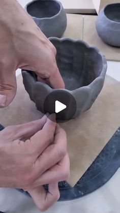 a person is working on some kind of bowl that's sitting on a table