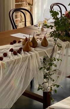 the table is set with pears and flowers for an elegant dining room decor idea