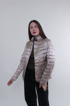 Hi! This is vintage from 90s Max Mara puffer jacket in light rose gold color. This lightweight rose gold jacket, made of NYLON and POLYESTER. MADE in R.P.C. Model on the photo is 170 cm tall and is wearing a MEDIUM size vintage puffer jacket. But, be careful, this is a vintage size, it is better to check the measurements below in the product description. Sleeve - 50cm / 19.68inch;  Width - 44cm / 17.32inch;  Length - 65cm / 25.59inch. All measurements are taken seam to seam while lying flat. Add Casual Fitted Gold Outerwear, Gold Fitted Casual Outerwear, Casual Fitted Metallic Outerwear, Casual Metallic Outerwear For Spring, Casual Gold Outerwear For Winter, Fitted Beige Puffer Jacket For Spring, Rose Gold Jacket, Vintage Puffer Jacket, Gold Jacket