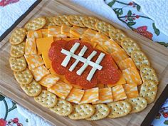 a football shaped cheese and cracker platter