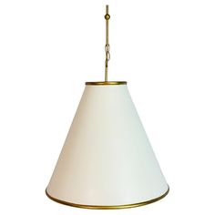 a white lamp hanging from a gold chain