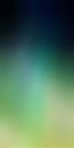 a blurry image of green and blue colors