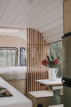 the interior of a camper with a bed and table