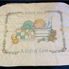 a baby is sleeping on top of a blanket with teddy bears around it and the words, babies are a gift of love