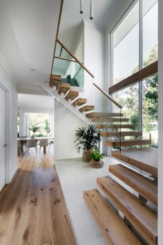 a wooden staircase with glass balconies leading up to the second floor