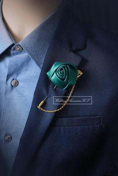 a blue suit with a green rose on it