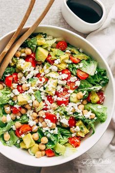 a white bowl filled with salad on top of a table