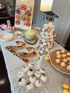 a table topped with lots of desserts and pastries