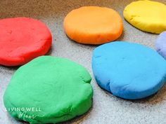 four colorful cookies sitting on top of a counter